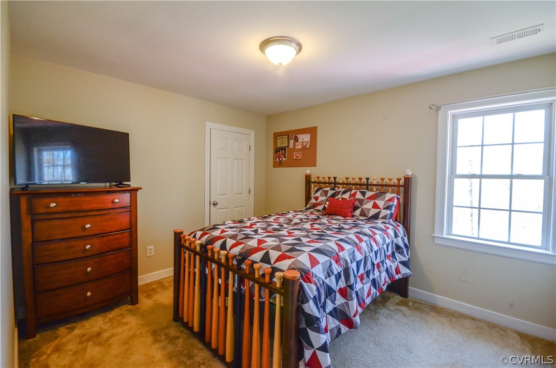 4400 Spring Rock Road Gum Spring, VA 23065 - Photo 25 of 35 a bedroom with a bed and a flat screen tv