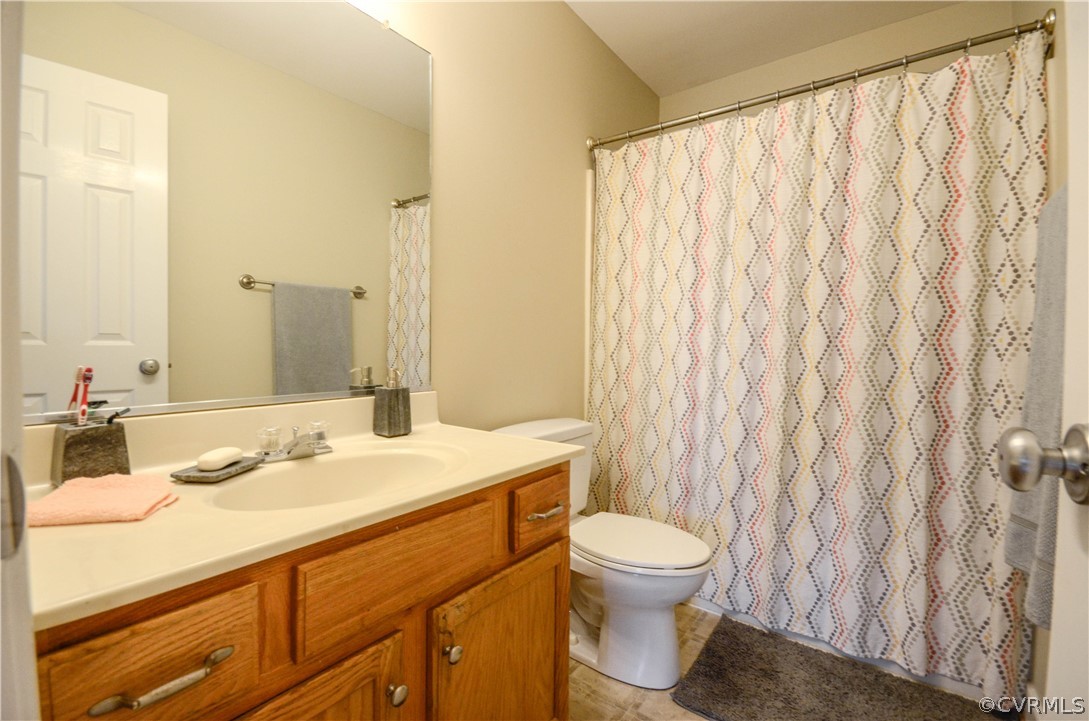 4400 Spring Rock Road Gum Spring, VA 23065 - Photo 28 of 35 a bathroom with a sink a toilet and a mirror