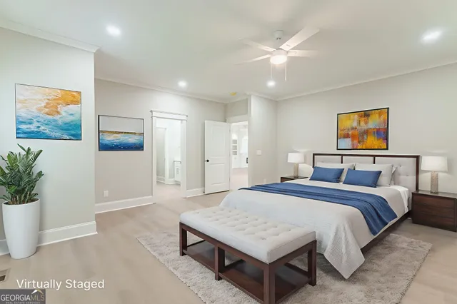 a bedroom with a large bed and a flat tv screen