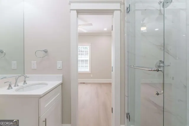 a view of an empty room with window and front door
