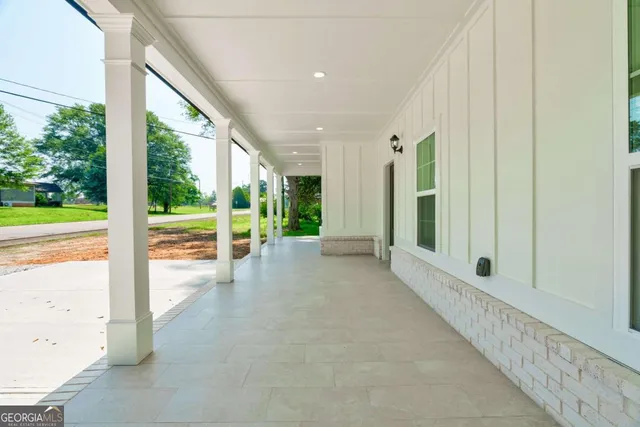 a aerial view of a house with a yard and large tree