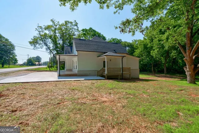 a stone house with a trees in the background