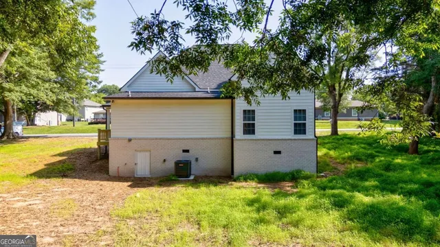 an aerial view of a house with a yard