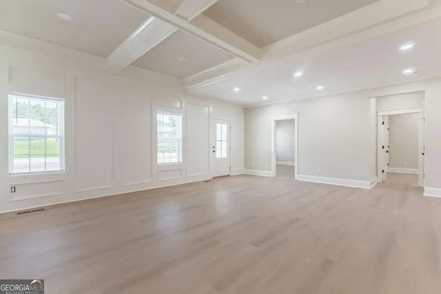 a view of an empty room with a kitchen