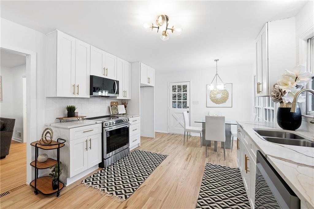 2520 Overlook Way Northeast Atlanta, GA 30345 - Photo 14 of 31 a kitchen with a dining table cabinets and appliances