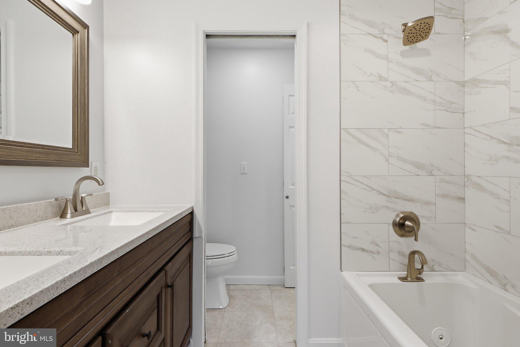 5538 Vantage Point Road Columbia, MD 21044 - Photo 21 of 50 a bathroom with a granite countertop sink a toilet and shower