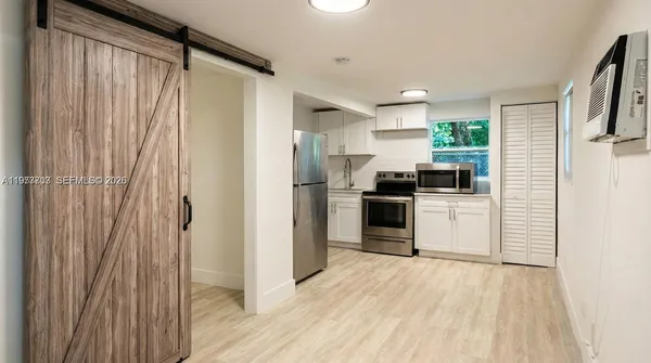 a kitchen with stainless steel appliances a refrigerator and a stove top oven