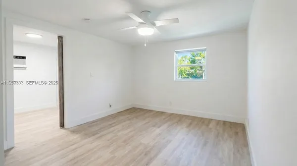 wooden floor in an empty room with a window