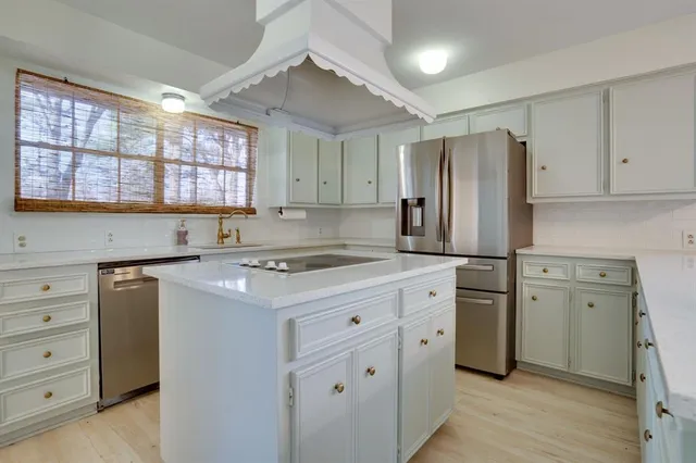 a kitchen with a stove a sink and a refrigerator