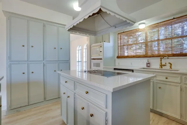 a kitchen with stainless steel appliances granite countertop a sink and dishwasher with wooden cabinets