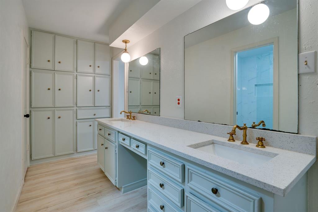 890 Copper Canyon Road Copper Canyon, TX 76226 - Photo 22 of 37 a spacious bathroom with a granite countertop sink and a mirror