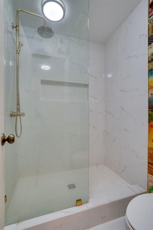 890 Copper Canyon Road Copper Canyon, TX 76226 - Photo 24 of 37 a bathroom with a shower and toilet