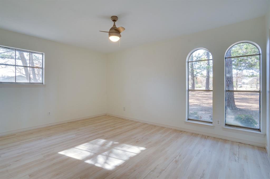 890 Copper Canyon Road Copper Canyon, TX 76226 - Photo 28 of 37 an empty room with wooden floor fan and windows