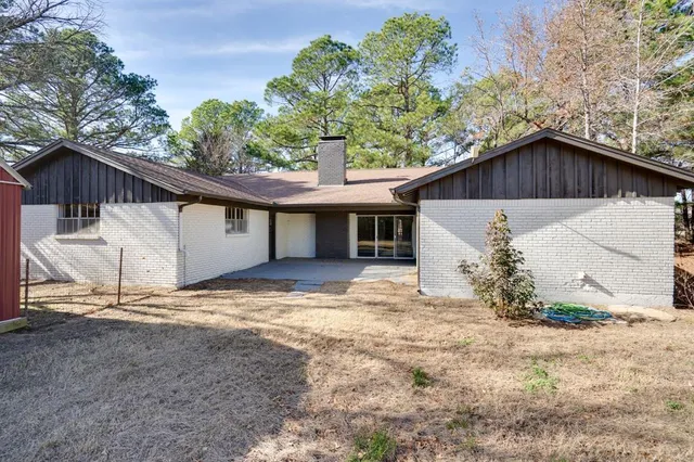 a view of a house with a yard and garage