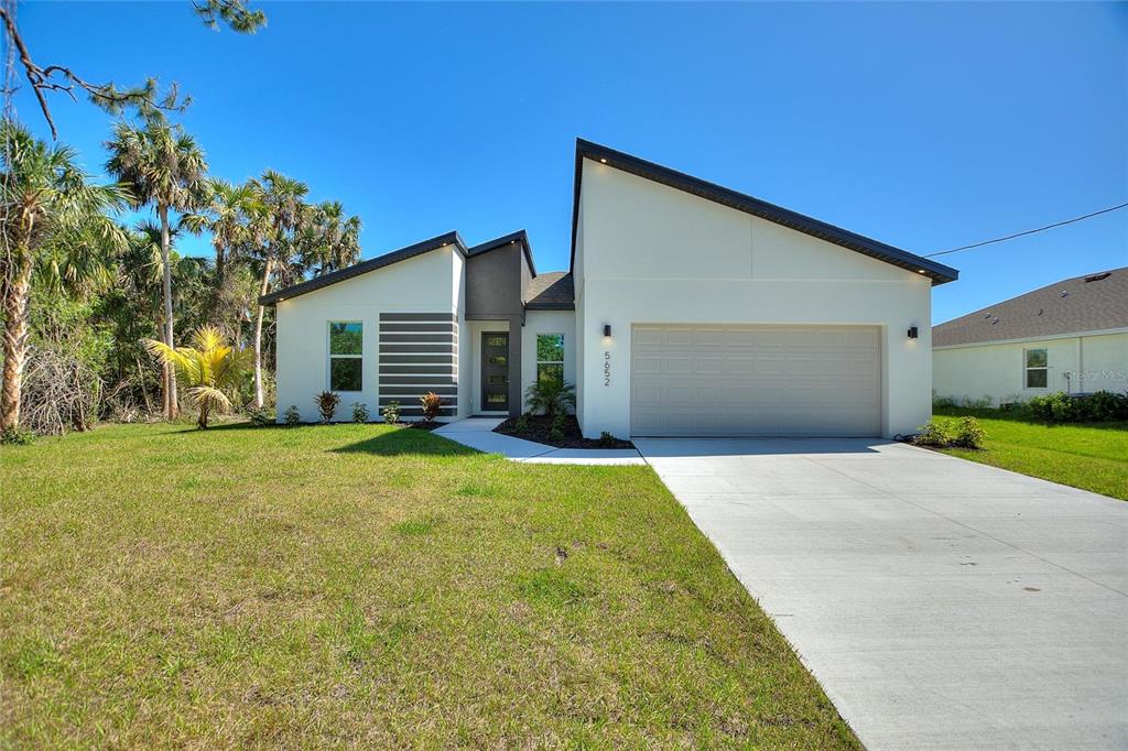 5652 Bannock Circle North Port, FL 34288 - Photo 1 of 1 a front view of a house with a yard and garage
