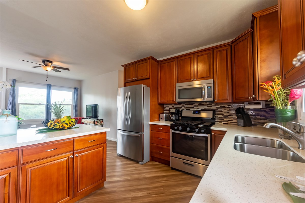 4517 Kala Road Kekaha, HI 96752 - Photo 3 of 19 a kitchen with stainless steel appliances granite countertop a refrigerator stove and sink