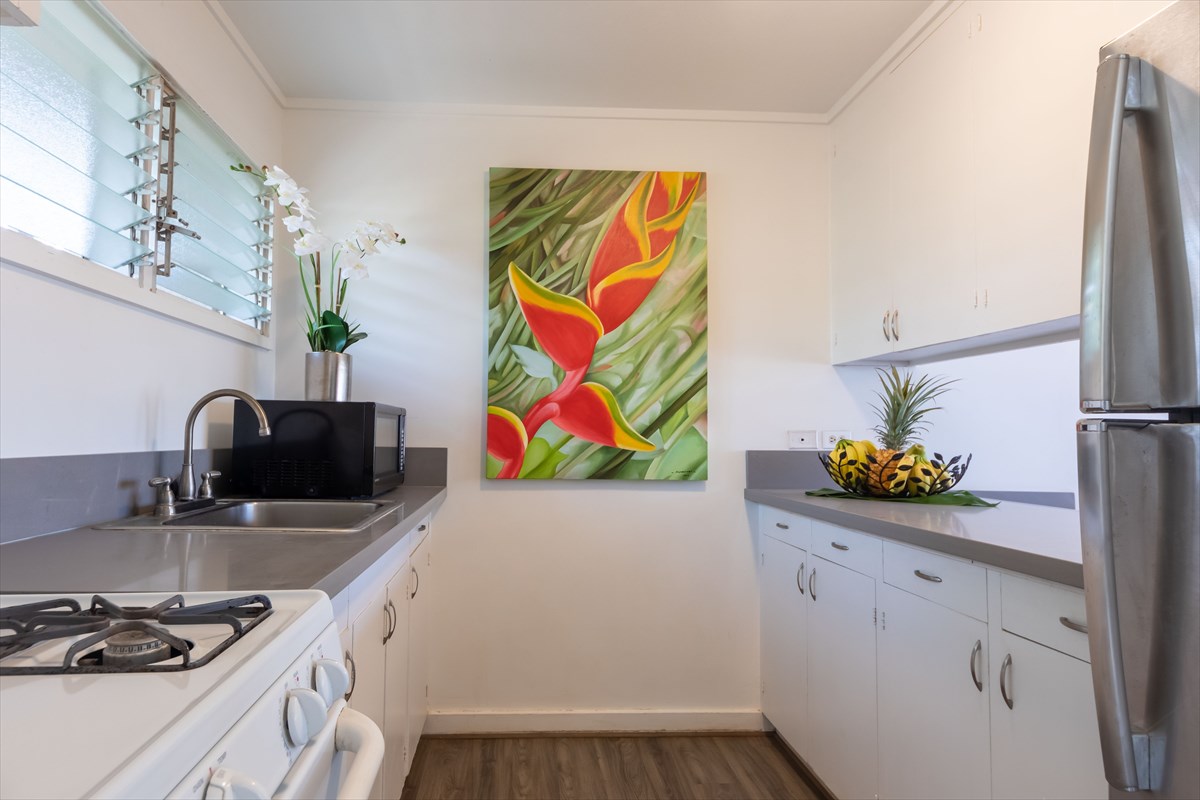 4517 Kala Road Kekaha, HI 96752 - Photo 9 of 19 a kitchen with stainless steel appliances a stove a sink and a microwave