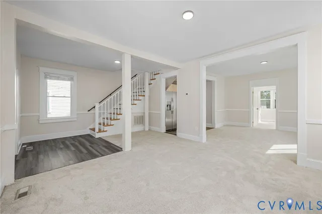 an empty room with windows and entryway