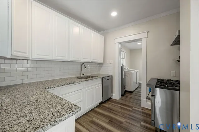 a kitchen with a sink stove and cabinets