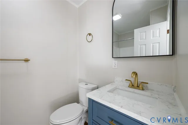 a bathroom with a sink a toilet and mirror