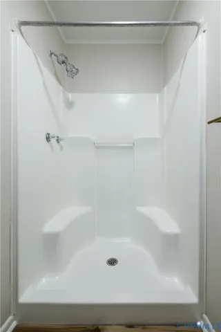 a view of bedroom with a bed and wooden floor