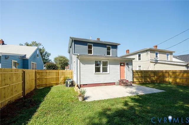 a view of a house with a yard and sitting area