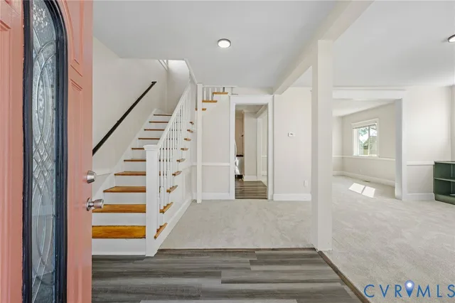 a view of entryway and hall with wooden floor