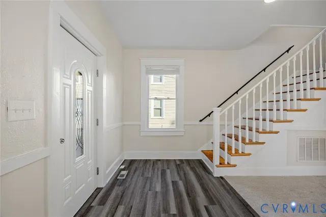 a view of entryway and hall with wooden floor