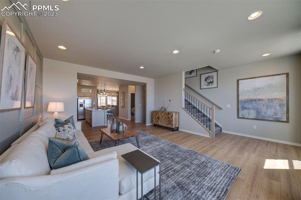 6069 Inman View Colorado Springs, CO 80924 - Photo 6 of 13 a living room with furniture and wooden floor