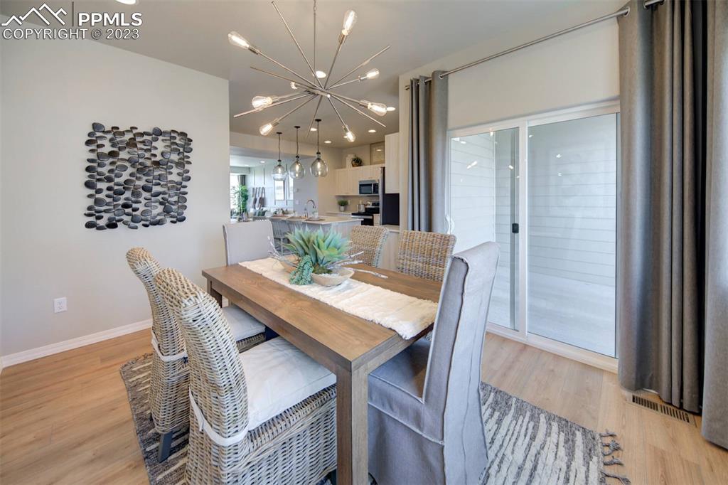 6069 Inman View Colorado Springs, CO 80924 - Photo 8 of 13 a view of a dining room with furniture and wooden floor