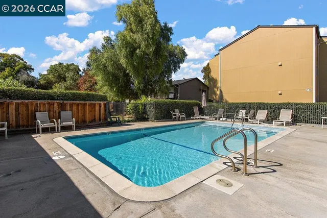 swimming pool view with a seating space