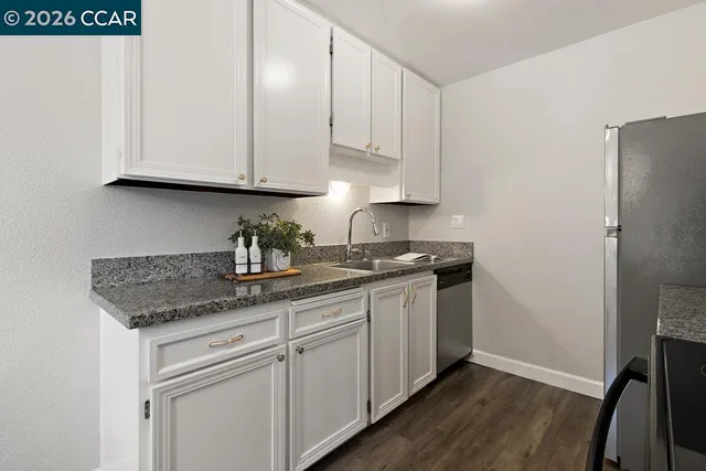 a kitchen with appliances cabinets and a counter top space