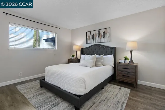 a bedroom with a bed and a night stand