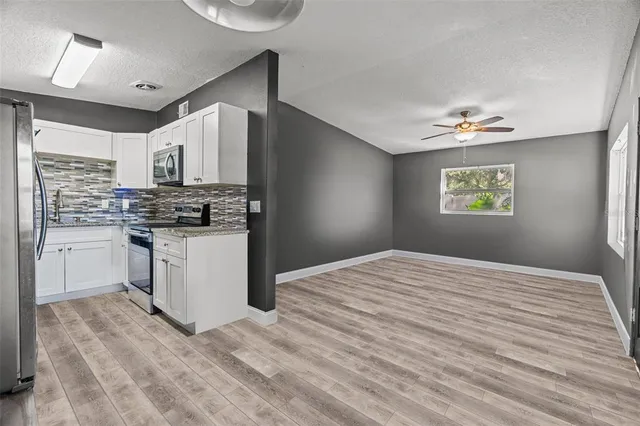 a kitchen with stainless steel appliances granite countertop a stove a sink dishwasher and a refrigerator