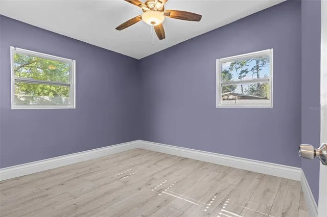 a view of room with window and ceiling fan