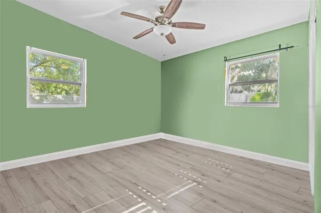 a view of room with window and ceiling fan