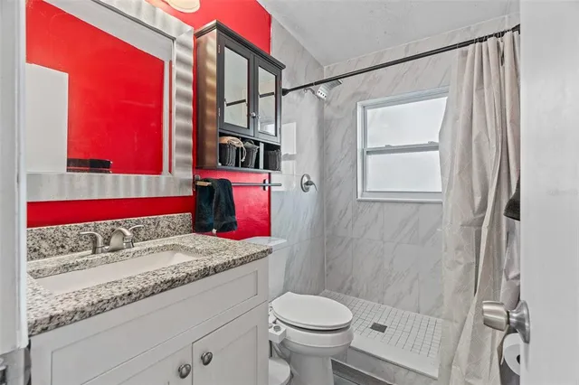 a bathroom with a sink toilet and shower
