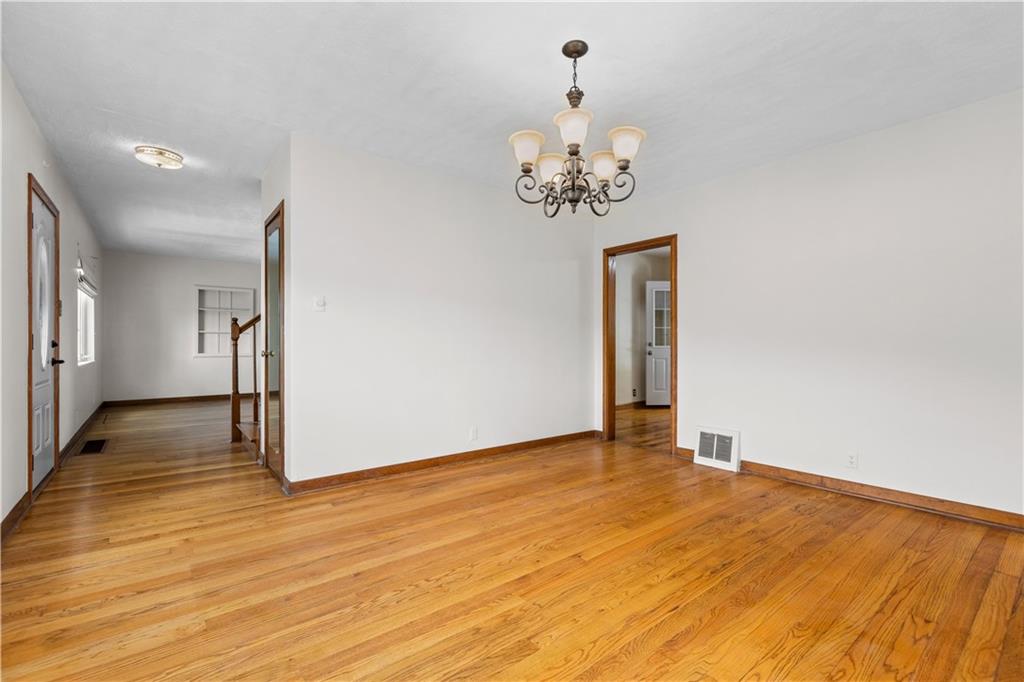 1580 Brush Run Road Washington, PA 15301 - Photo 15 of 27 a view of a livingroom with wooden floor and a ceiling fan