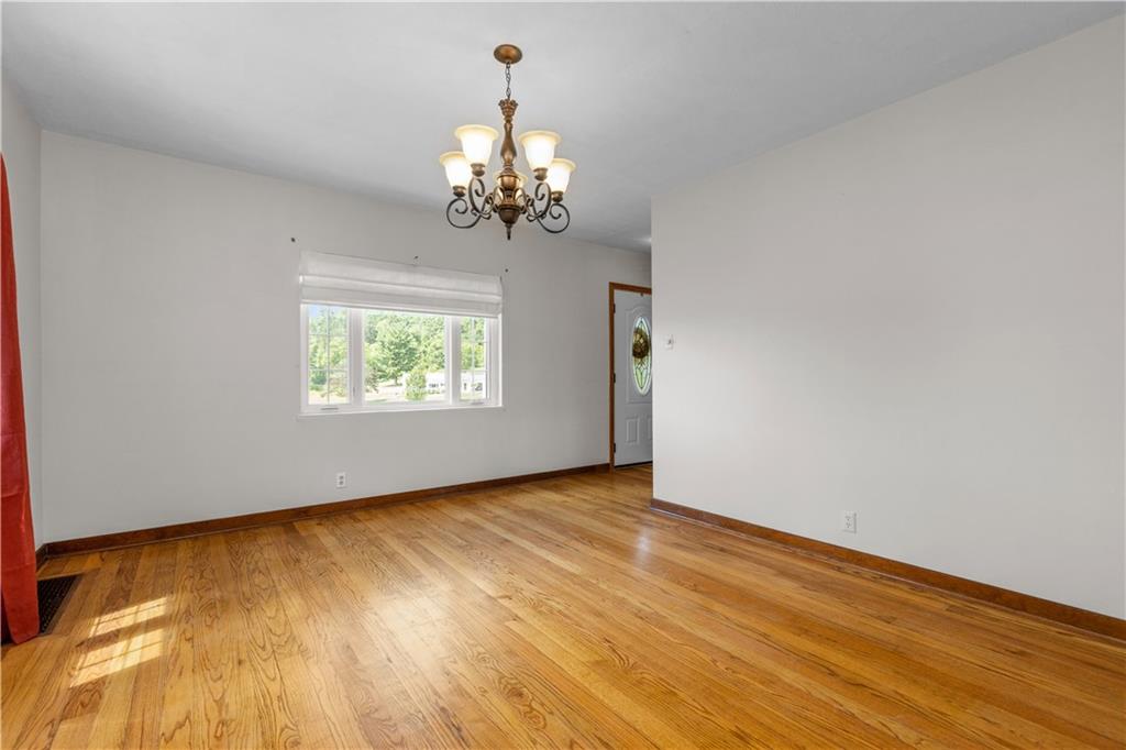 1580 Brush Run Road Washington, PA 15301 - Photo 16 of 27 a view of an empty room with wooden floor and a window