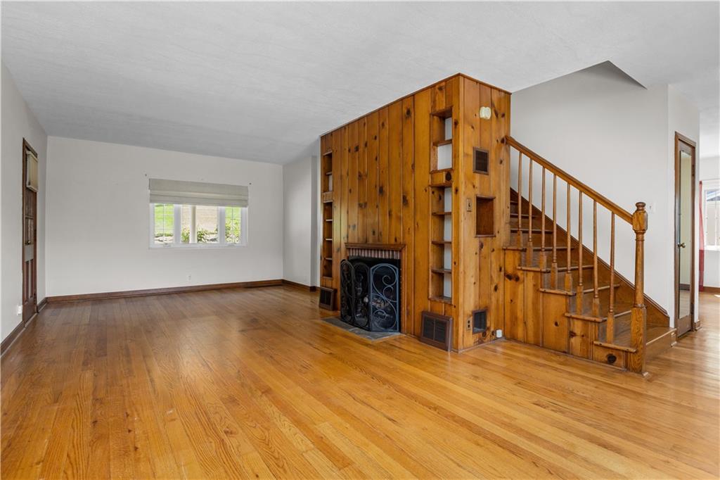 1580 Brush Run Road Washington, PA 15301 - Photo 9 of 27 wooden floor with fireplace and windows