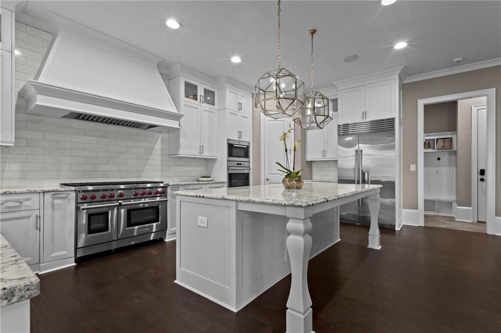 490 Belada Boulevard Atlanta, GA 30342 - Photo 12 of 42 a kitchen with stainless steel appliances granite countertop a stove and a refrigerator