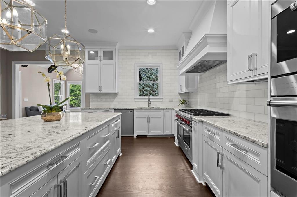 490 Belada Boulevard Atlanta, GA 30342 - Photo 14 of 42 a kitchen with granite countertop a sink stainless steel appliances and cabinets