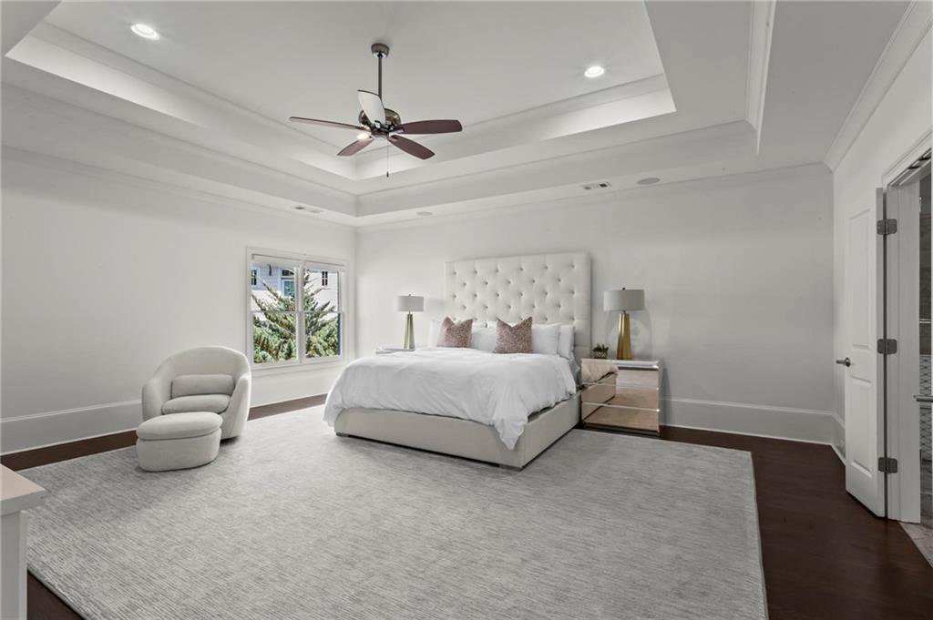 490 Belada Boulevard Atlanta, GA 30342 - Photo 17 of 42 a spacious bedroom with a bed and a chandelier