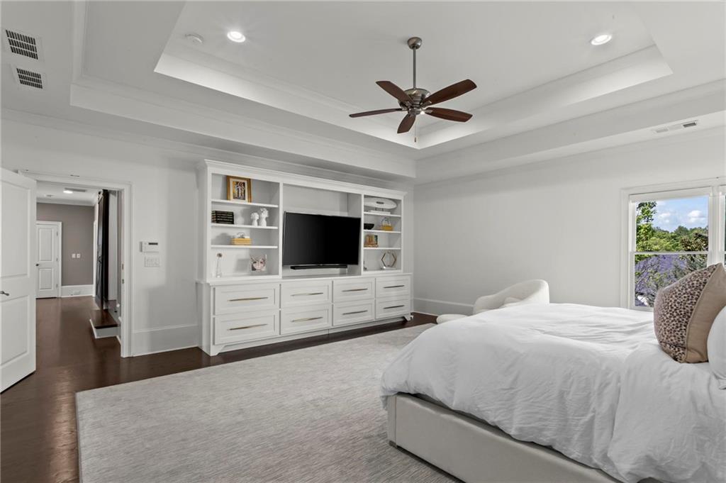 490 Belada Boulevard Atlanta, GA 30342 - Photo 18 of 42 a bedroom with a large bed and a flat screen tv