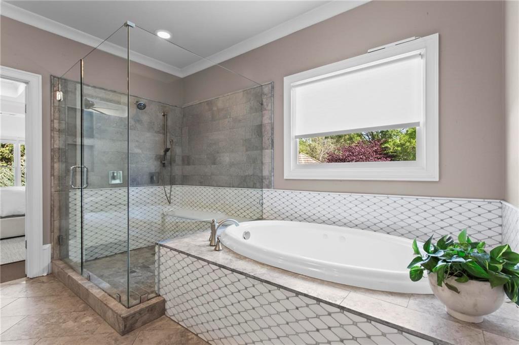 490 Belada Boulevard Atlanta, GA 30342 - Photo 20 of 42 a bathroom with a bathtub and a shower