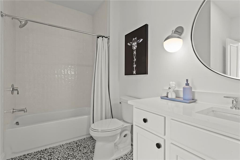 490 Belada Boulevard Atlanta, GA 30342 - Photo 27 of 42 a bathroom with a sink a toilet and a mirror