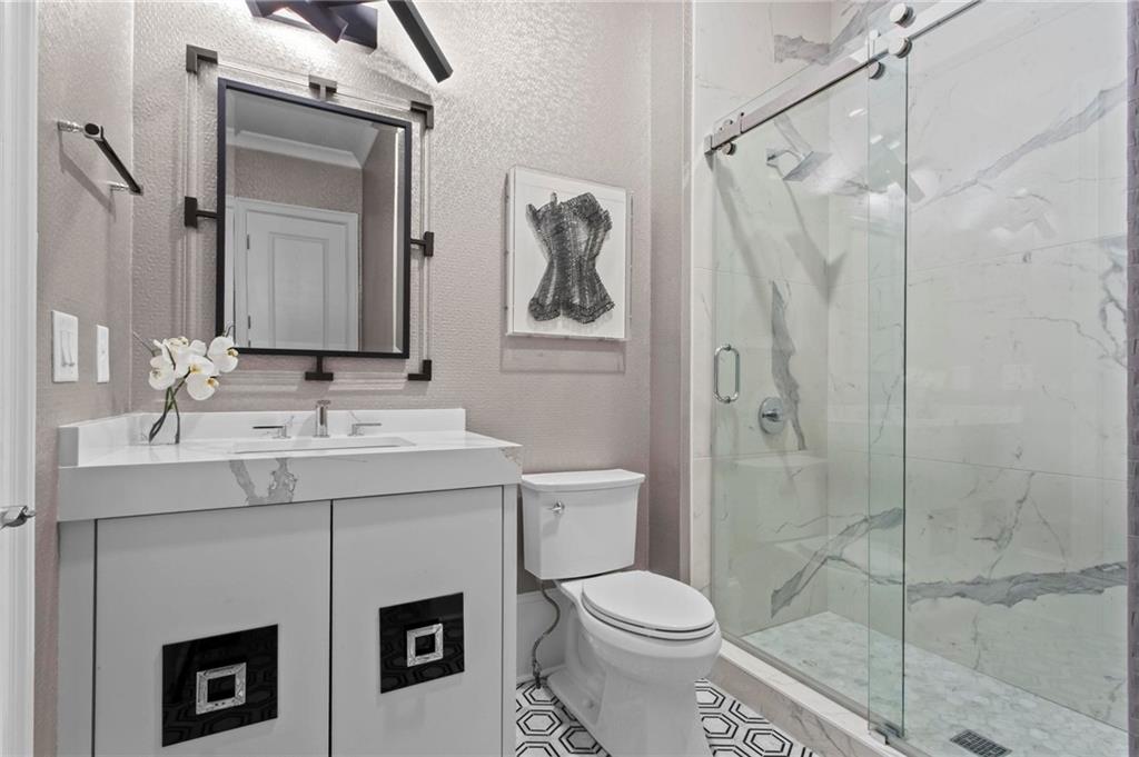 490 Belada Boulevard Atlanta, GA 30342 - Photo 29 of 42 a bathroom with a sink a toilet and shower