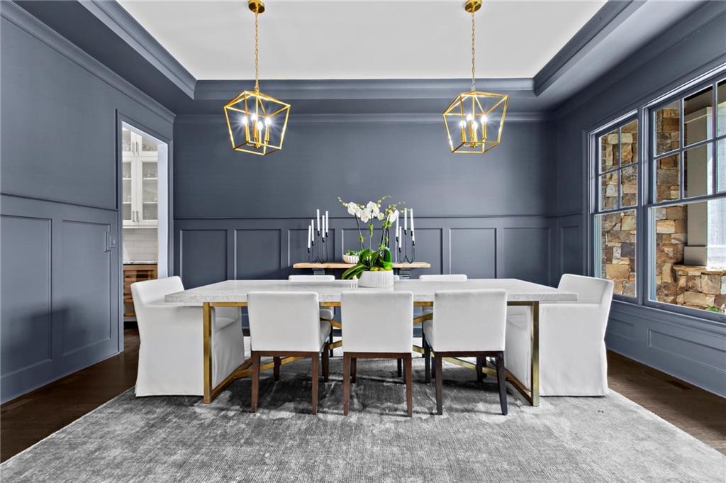 490 Belada Boulevard Atlanta, GA 30342 - Photo 5 of 42 a view of a dining room with furniture a chandelier and wooden floor