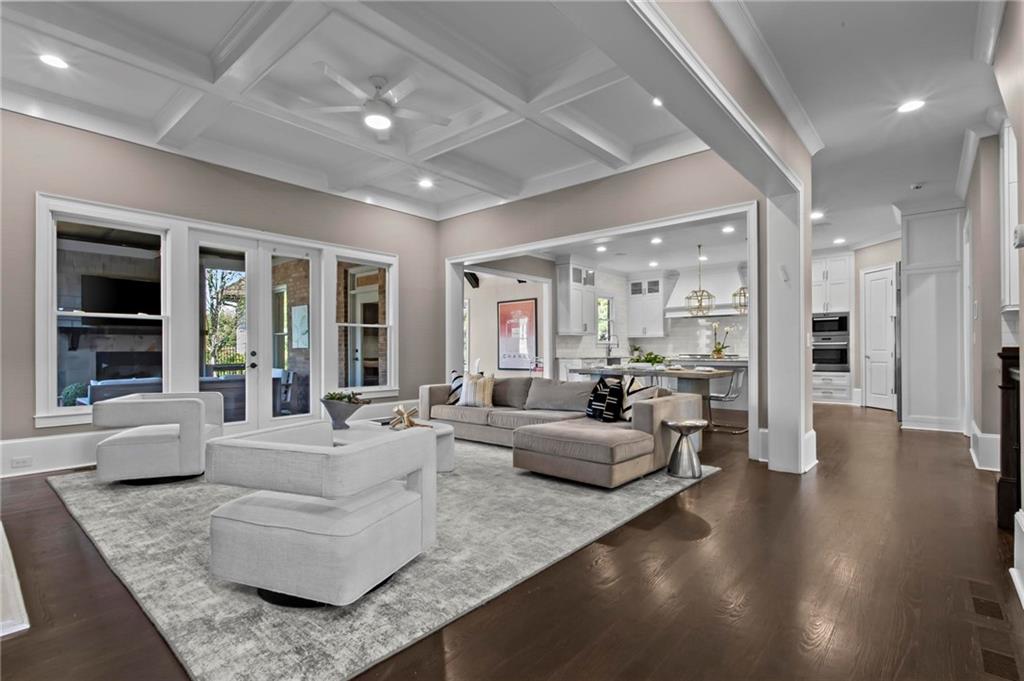 490 Belada Boulevard Atlanta, GA 30342 - Photo 8 of 42 a living room with couches and kitchen view with wooden floor