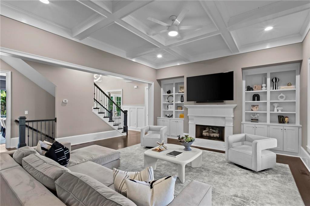 490 Belada Boulevard Atlanta, GA 30342 - Photo 9 of 42 a living room with furniture a flat screen tv and a fireplace